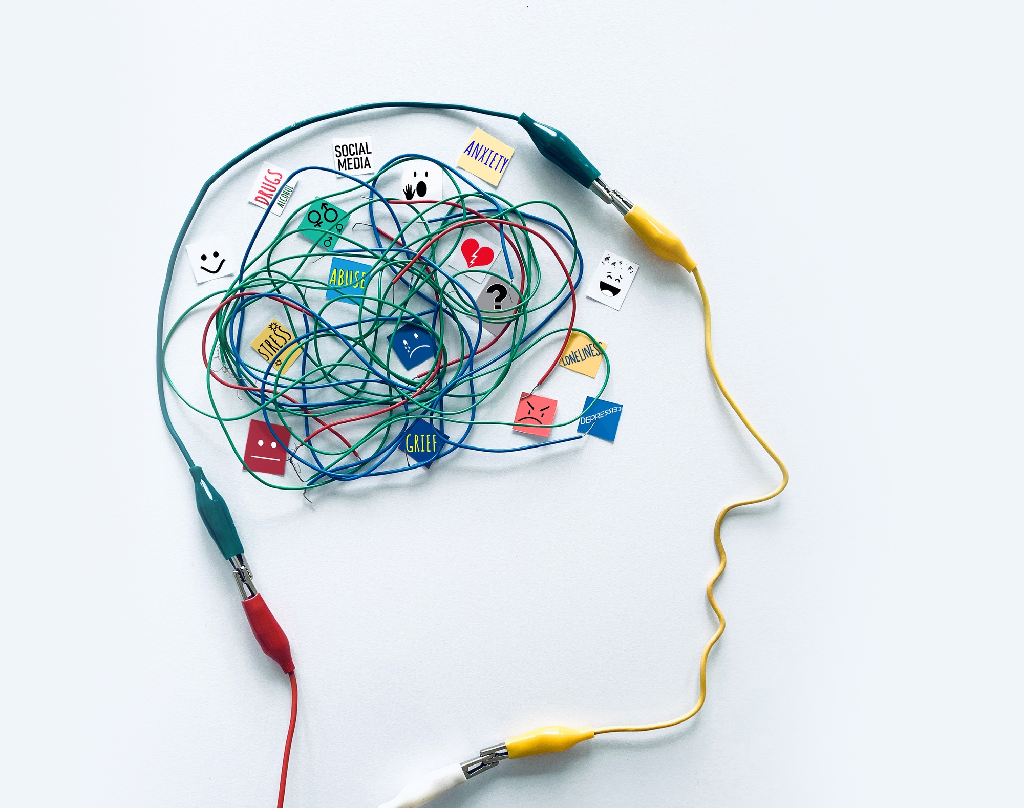 illustration of tangled wires shaped like a human head symbolizing mental health challenges such as anxiety, grief, and abuse, used in a blog on the link between sleep apnea and mental health by Sierra Sleep, Airway and Wellness Center in Reno, NV